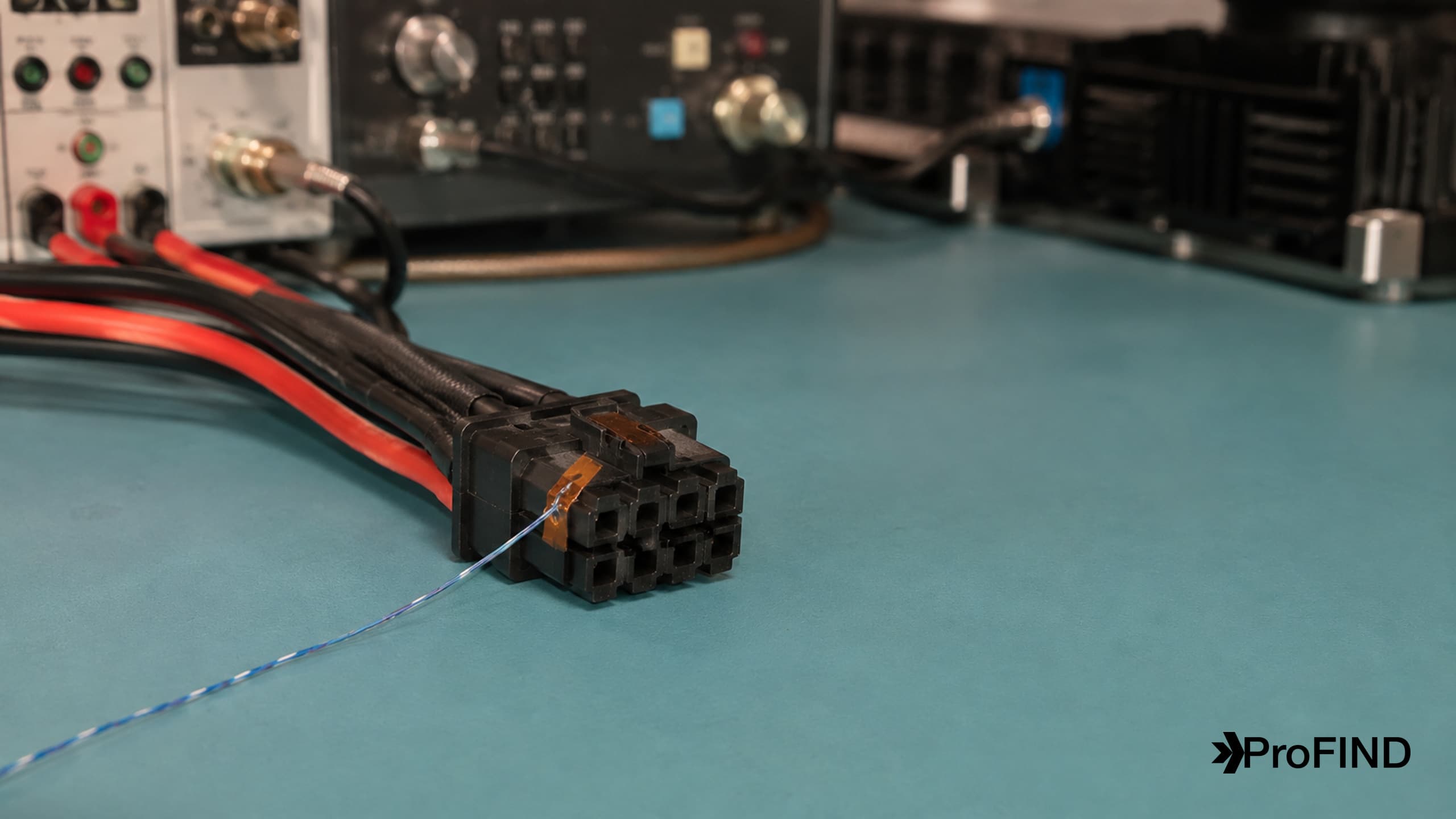 A wired power connector with a thermocouple attached during a laboratory temperature test