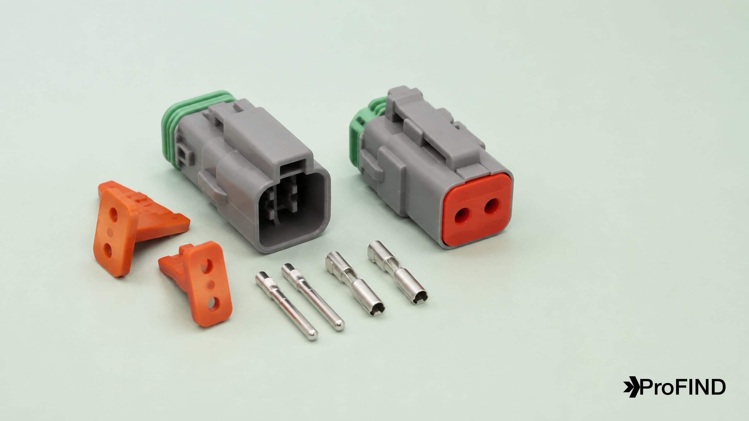Gray sealed two-way connector housings, orange wedge inserts, green seals, and machined contacts