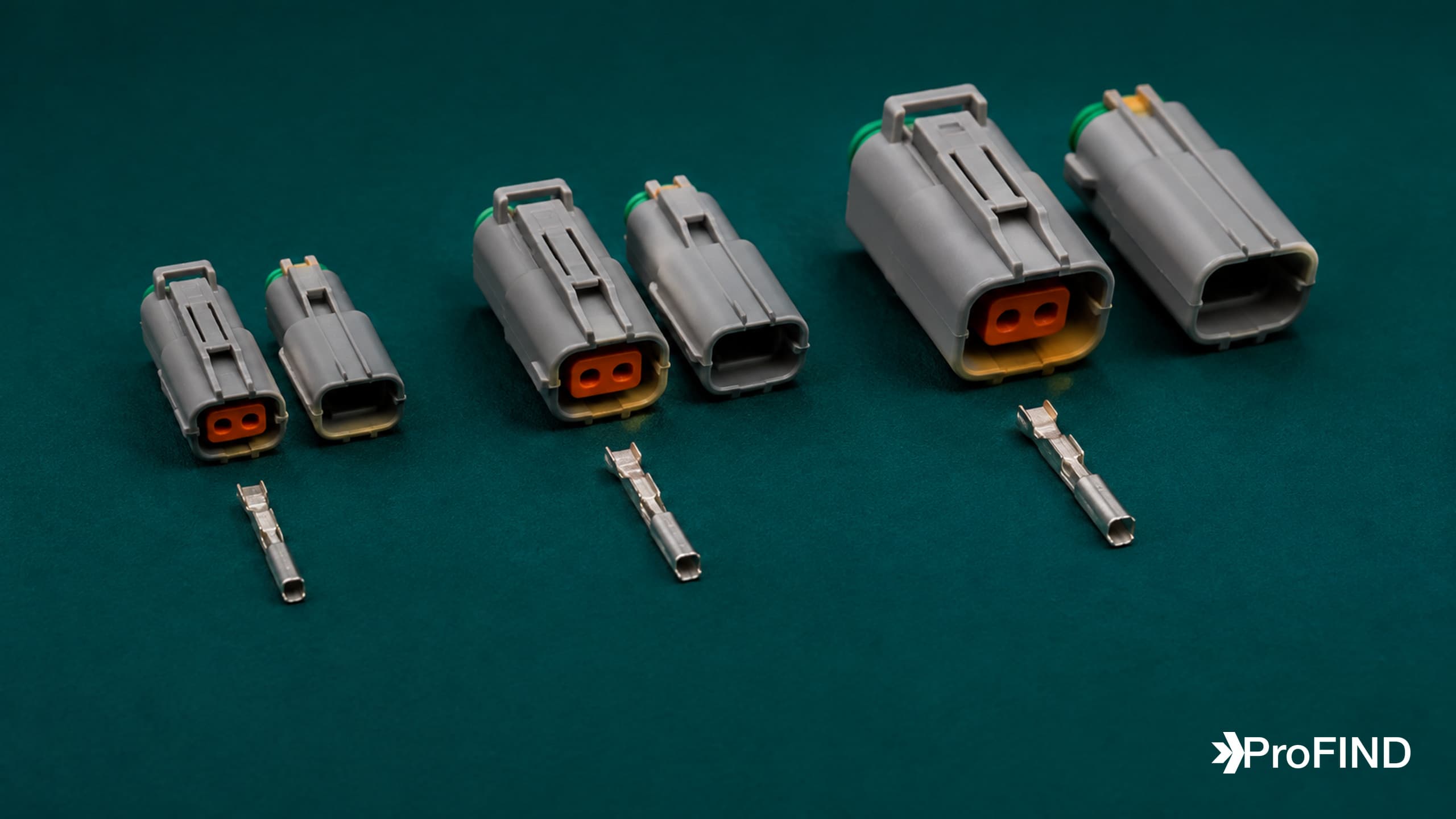 Three sizes of gray sealed connector pairs with corresponding metal contacts on teal