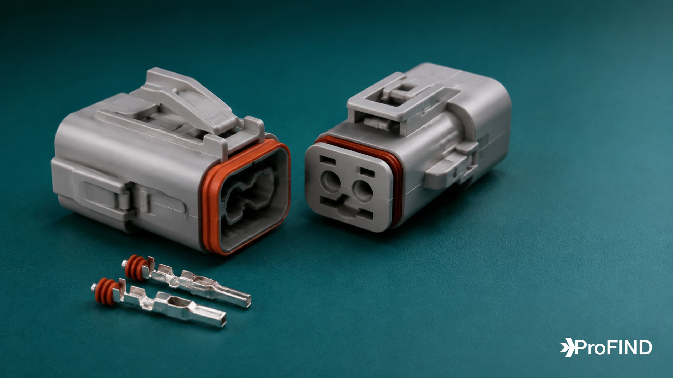 Matched gray sealed automotive connector housings and metal contacts on a teal surface